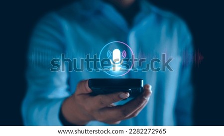 Voice recording. Man touching microphone icon on smart phone. Mobile application Record sound, audio, music, voice message. or Use your voice to direct AI to search for information on Internet. Royalty-Free Stock Photo #2282272965