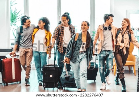 Young group of tourists with suitcases arriving at youth hostel guest house - Happy friends enjoying summer vacation together - Millenial people doing check-in at hotel lobby - Summertime holidays Royalty-Free Stock Photo #2282276407