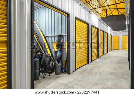 Corridor of self storage unit with yellow doors. Rental Storage Units Royalty-Free Stock Photo #2282299441