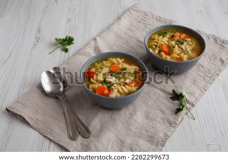 Homemade Chicken Noodle Soup in a Bowl, side view.