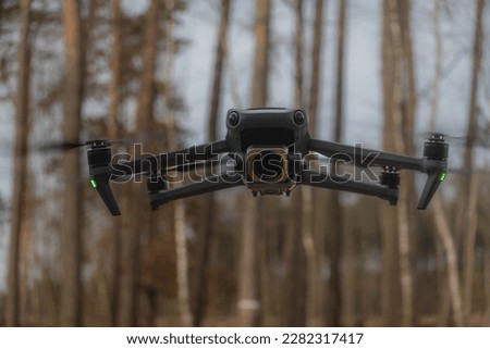 Photo of Mavic Drone. Close-up of a drone in flight amidst a lush forest. Perfect for nature and tech-themed projects. Download now to enhance your visuals.
