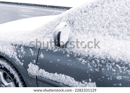Snowy season. The car is a completely covered snow. Winter landscape