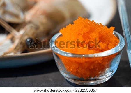 Focused on fresh Tobiko, flying fish roe with blur Shrimp beside it.