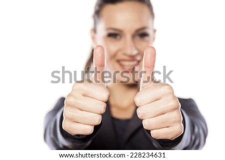 Beautiful business woman showing thumbs up