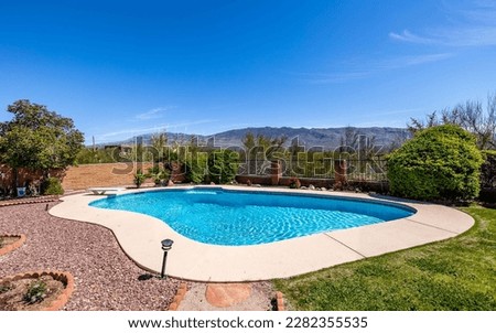 A courtyard of a pretty low tree-lined villa. Exterior view of a beautiful house with a swimming pool Royalty-Free Stock Photo #2282355535