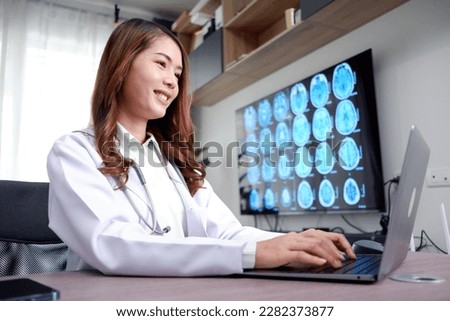 female doctor using laptop to record patient information.