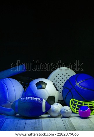 Sports equipment, rackets and balls on hardwood court floor with neon light background. Vertical education and sport poster, greeting cards, headers, website
