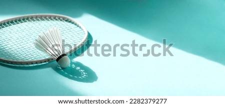 Badminton racket and shuttlecock on mint color background. Horizontal sport theme poster, greeting cards, headers, website and app