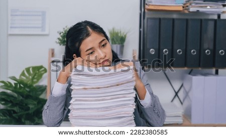 stressed, mad, migraine, Young confident asian business woman office worker people working with stack of papers, unfinished documents of bookkeeping. Royalty-Free Stock Photo #2282380585