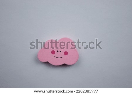 Pink cloud.  Pink cloud over white background, photographed from above.  emoji happy