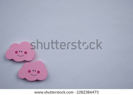 Pink clouds.  Pink clouds, photographed from above, placed on the edge of a white background.  emoji happy