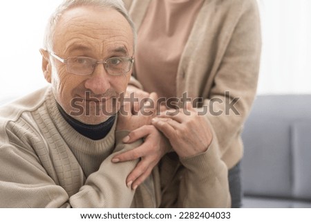Head shot old male pensioner involved in rehabilitation procedure with caring young physiotherapist. retired man with walking disability feeling thankful for professional help. Royalty-Free Stock Photo #2282404033