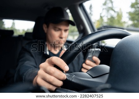 Driving car and using phone to text. Driver using cellphone. Accident, crash and danger in traffic. Man texting with mobile app. Distracted by mobilephone. Checking sms message with smartphone. Royalty-Free Stock Photo #2282407525