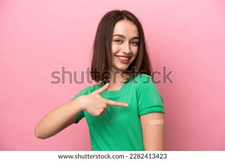 Young Ukrainian woman wearing a band aids and pointing it