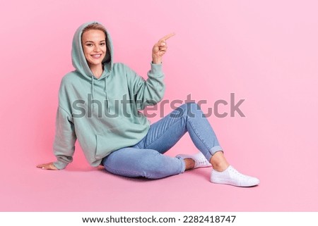 Full length photo of adorable positive lady demonstrate empty space presenting cool shop low prices isolated on pink color background
