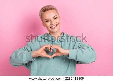 Photo portrait of lovely young lady arms show heart shape gesture toothy smile wear trendy khaki outfit isolated on pink color background
