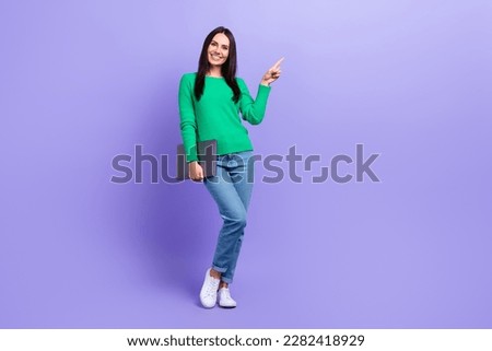 Photo of confident business woman direct finger empty space hold modern technology netbook advertisement concept