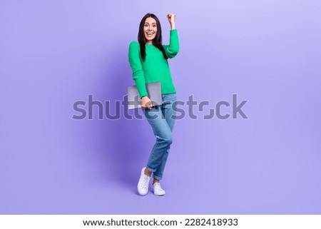 Full length photo of excited happy businesswoman hold mini netbook laptop celebrate startup success isolated purple color background