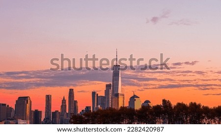 New York City's Lower Manhattan skylines during sunset with the famous One World Trade Center building