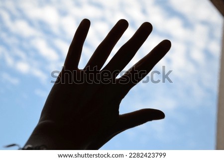 Silhouette of a hand and the sky