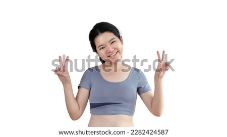 Young Asian woman making two thumbs up gesture showing joy and fun, Symbol of good friendship, Popular photo poses, Make a v-shaped finger, White background.