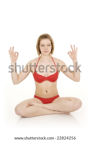 Caucasian teenager practicing yoga in a red bikini on a white background
