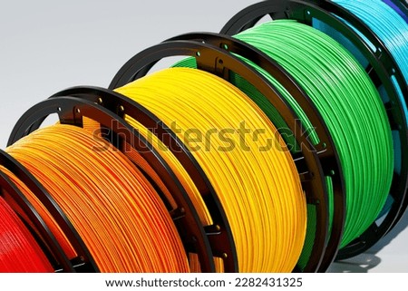 Multicolored filaments spools of plastic for 3D printer. 3D printing technology Royalty-Free Stock Photo #2282431325