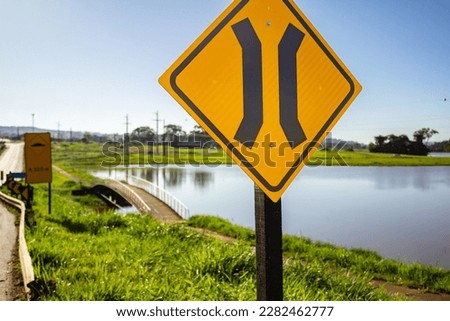 ANICUNS GOIAS BRAZIL - MARCH 26 2023: Bridge narrowing signpost beside the "River of Oxen" in the city of Anicuns.