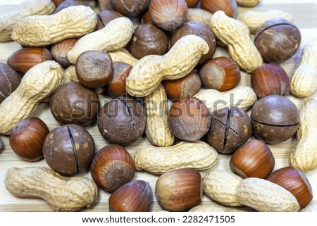 Healthy food concept, rich harvest concept. Close-up of peanuts, hazelnuts, brazil nuts (macadamia). Macro, selective focus, horizontal photo. Kyiv, Kiev, Ukraine, Europe.