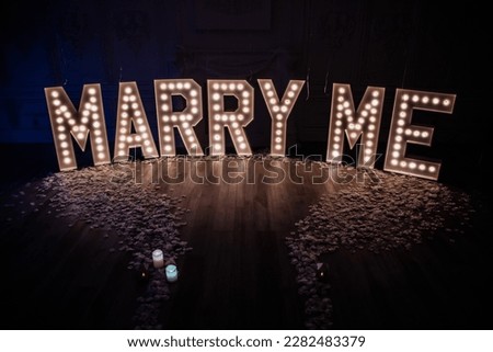 Marry Me Decor setup with marquee letters Royalty-Free Stock Photo #2282483379