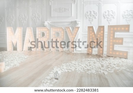 Marry Me Decor setup with marquee letters Royalty-Free Stock Photo #2282483381