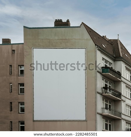 big white or empty billboard on apartment block side wall, your content here, poster mock up. Royalty-Free Stock Photo #2282485501