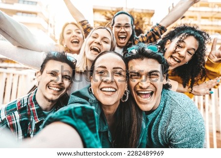 Happy multiracial friends taking selfie pic outside - Cheerful young people smiling together at camera - Life style concept with guys and girls hanging out on summer vacation - Bright filter