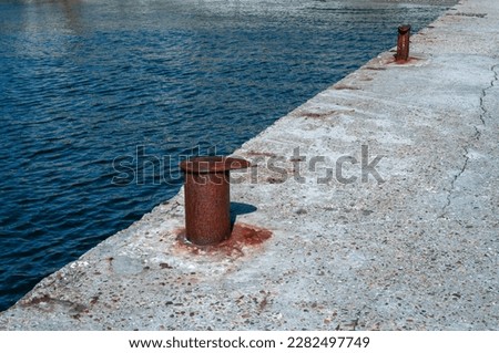 Rusty marine bollard on the pier