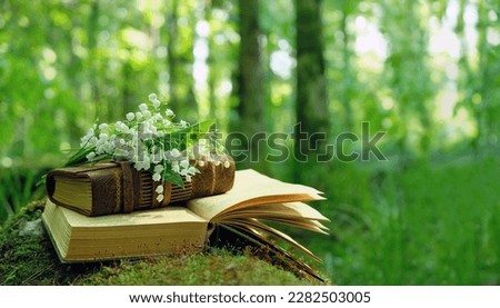 spring nature background. Lily of the valley flowers and old books in forest. symbol of spring season. romantic composition with flowers. template for design. copy space.