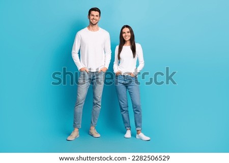 Full size photo of two positive people put hands pockets have good mood isolated on blue color background