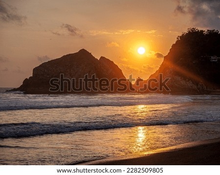 Sunset over the sea with mountains in the background