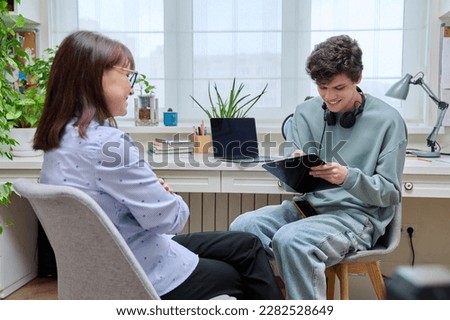Woman social worker, mentor interviewing, talking to young male in office Royalty-Free Stock Photo #2282528649