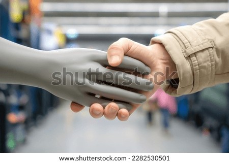 A handshake with a plastic dummy . The concept of man versus artificial intelligence is friendship or enmity, help with work or unemployment. AI generated generation. Royalty-Free Stock Photo #2282530501