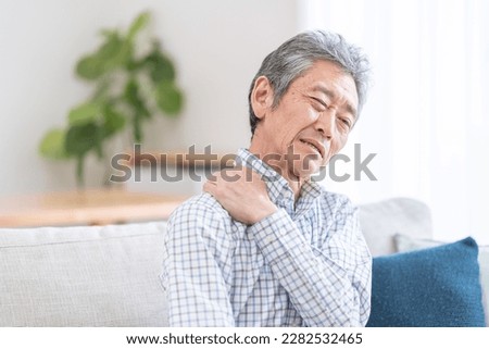 Elderly man with stiff shoulders Royalty-Free Stock Photo #2282532465