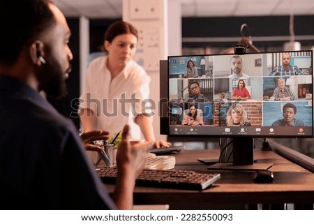 African american employee discussing business plan with remote team on teleconference, talking with colleagues on online meeting. Office worker attending videoconference, having corporate videocall Royalty-Free Stock Photo #2282550093