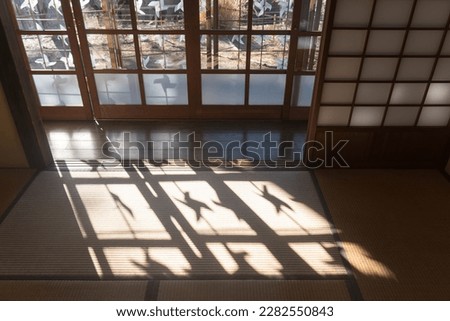 The shadow of a windmill reflected on the tatami mats of an old Japanese house Royalty-Free Stock Photo #2282550843