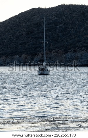 sailboat parked in calm waters of a bay