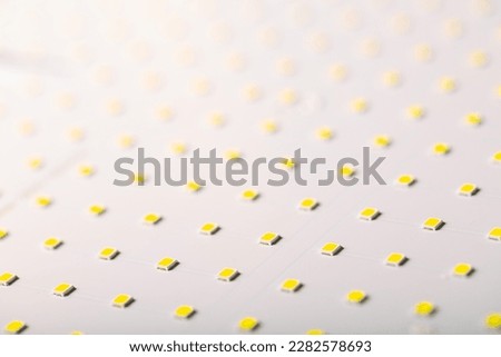 Close up of white LED panel with yellow light. Soft focus background.