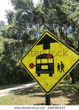 Bus stop caution sign to stop warning of children boarding or un boarding.