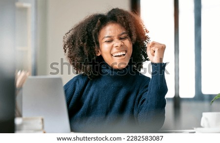 Excited happy african american woman feeling winner rejoicing online win got new job opportunity Royalty-Free Stock Photo #2282583087