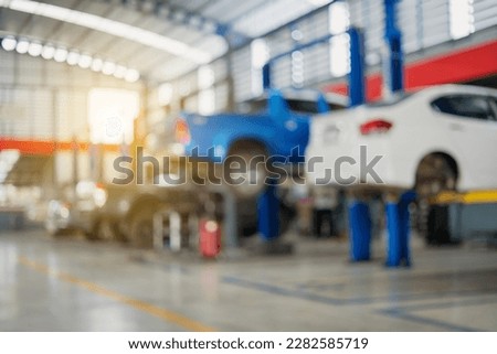 Blurred image of car inspection service center with modern tools Royalty-Free Stock Photo #2282585719