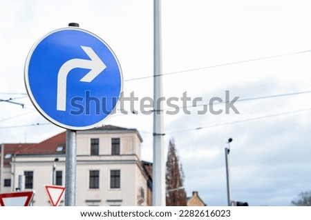 View of turn right sign in city, closeup Royalty-Free Stock Photo #2282616023