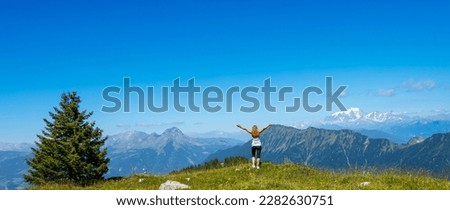 Hiker woman on the peak looking at panoramic mountain view Royalty-Free Stock Photo #2282630751