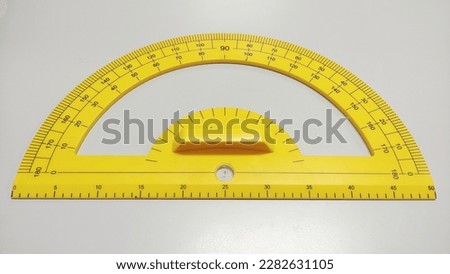 Yellow protractor ruler isolated on white background